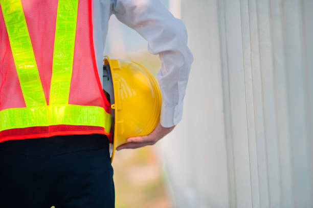 istock Engineer holding hard hat construction worker professional safety work industry building person manager service 1413826520
