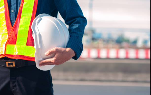 istock Engineer holding hard hat construction worker professional safety work industry building person manager service 1413826522