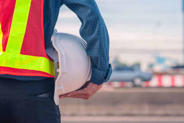 istock Engineer holding hard hat construction worker professional safety work industry building person manager service 1413826527