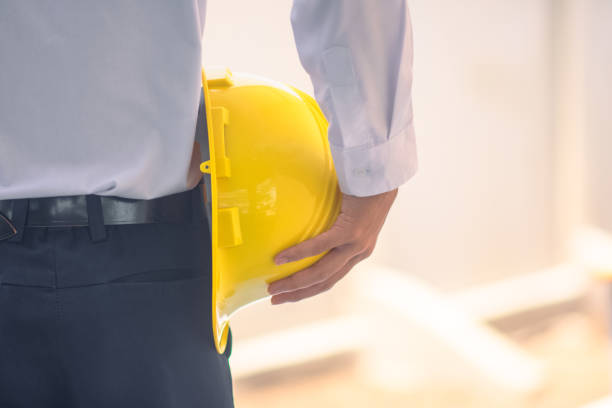 istock Engineer holding hard hat construction worker professional safety work industry building person manager service 1413826545