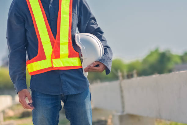 istock Engineer holding hard hat construction worker professional safety work industry building person manager service 1413826551