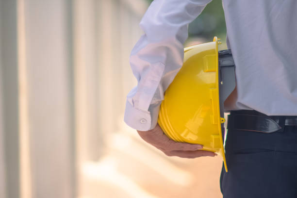istock Engineer holding hard hat construction worker professional safety work industry building person manager service 1413826552