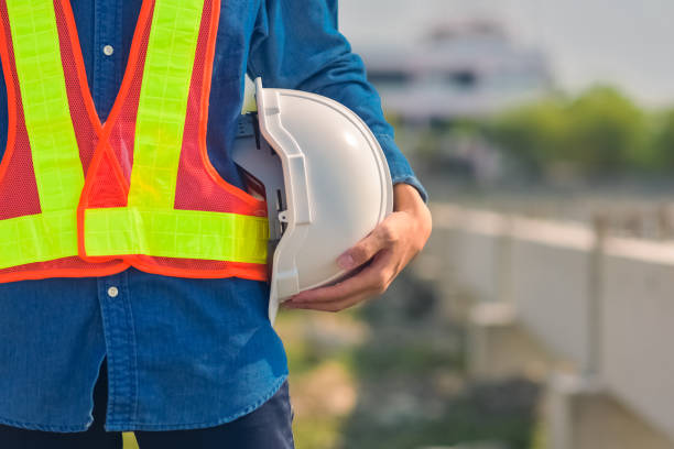 istock Engineer holding hard hat construction worker professional safety work industry building person manager service 1413826565