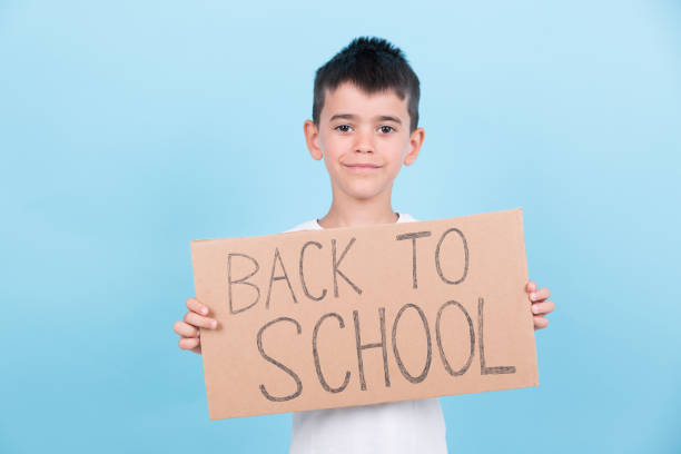 istock a boy holds a back-to-school poster 1413826881