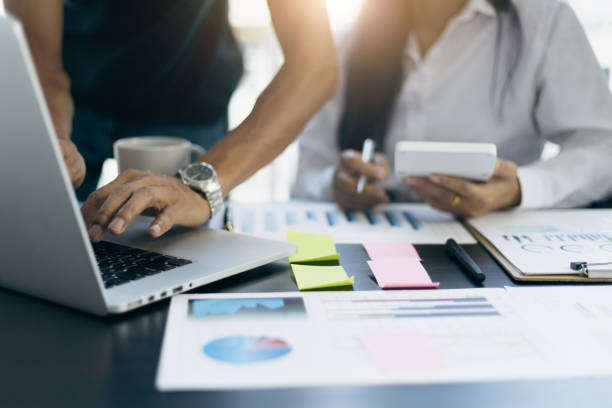 istock Accountants in the office working with laptops and calculators analyzing financial and auditing documents. 1413828392