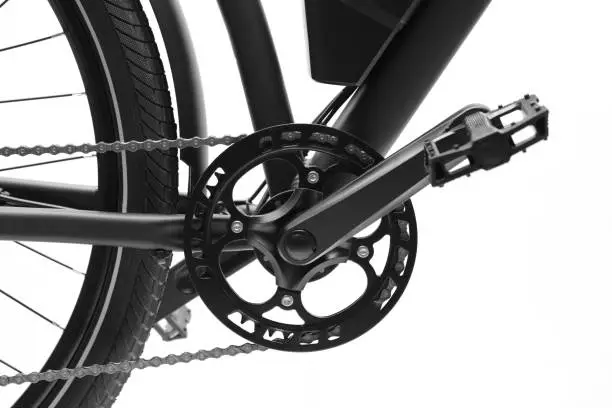 Side view of twisted pedals and chainring of the bicycle on white