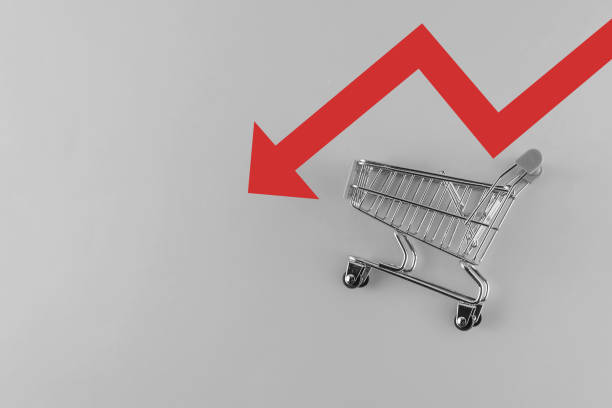 istock empty supermarket trolley on a gray background with a red arrow down. Crisis concept 1413830662