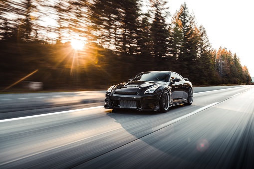 LA, CA, USA\nAugust 2, 2022\nBlack Nissan R35 GTR driving on the street with the sun going down