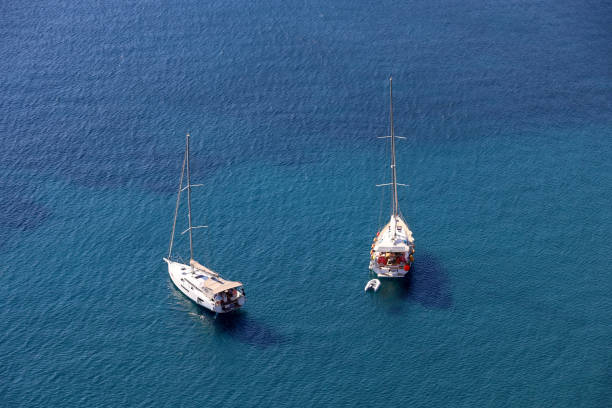 Two sailboats lying at anchor, background for traveling and vacation