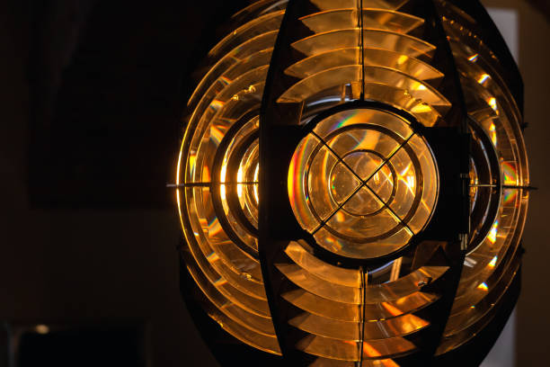 istock Lighthouse lamp glowing behind a Fresnel lens 1413833248