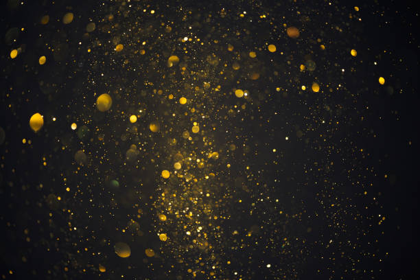 istock Gold glitter particles burst abstract bokeh 1413836666