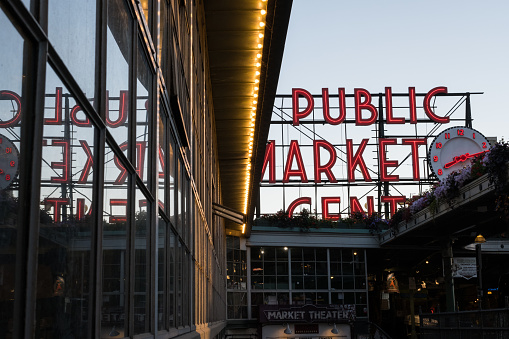 Seattle, USA - Aug 3, 2022: The famous illuminated Pike Place Market sign over Post Alley.
