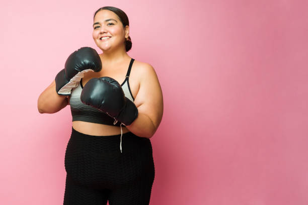 istock Portrait of a happy plus size woman practicing a boxing workout 1413839320