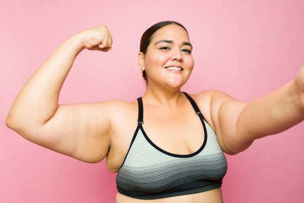 istock Beautiful plus size woman smiling and feeling strong after exercising 1413839461