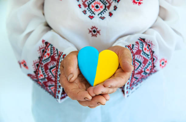 istock Midsection Of Woman Holding Heart Shape Candy 1413840410