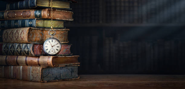 古い本の背景にある鎖にぶら下がっている古い時計。 時間の象徴としてのロック 本は知識の象徴です。歴史、郷愁、文化をテーマにしたコンセプト。 - history ストックフォトと画像