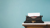 istock Old vintage typewriter on a table over an isolated background. 1413840629