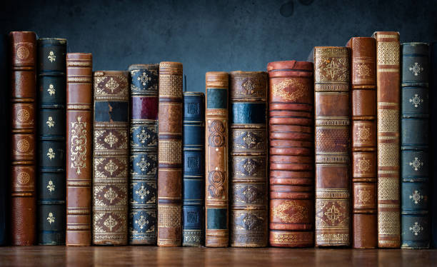 Old books on wooden shelf. Tiled Bookshelf background.  Concept on the theme of history, nostalgia, old age. Retro style. The book is a symbol of knowledge. stock photo