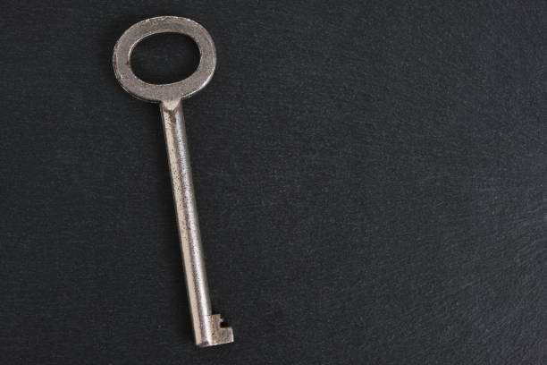 istock Old, retro vintage key dark background. 1413842717