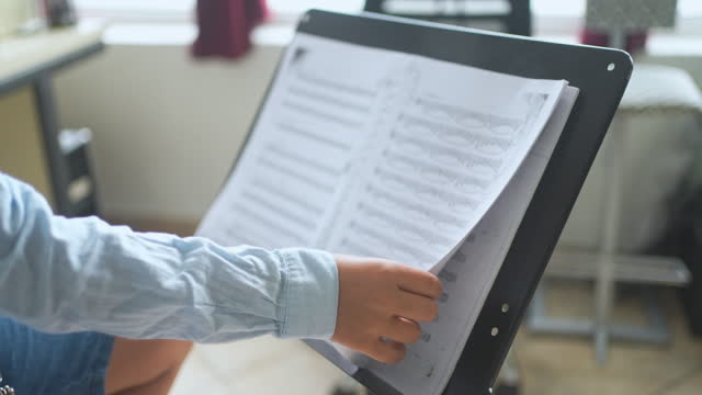 Child Using Book With Exercises For Clarinet