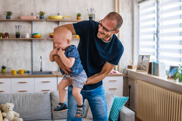 istock Time to fly! Father having fun with baby boy at home 1413843505