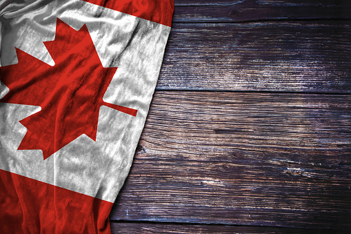 Tiny Canadian flag pair on light blue background. Horizontal composition with copy space. Directly above.