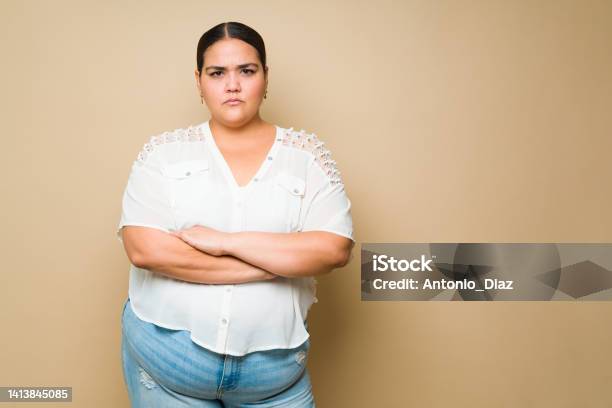 Upset Fat Woman Looking Annoyed And Looking At The Camera Stock Photo - Download Image Now