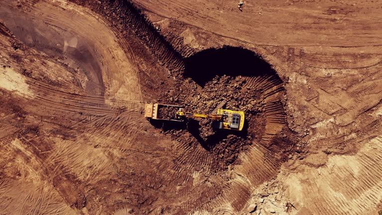 Excavator during clay mining in open-pit.