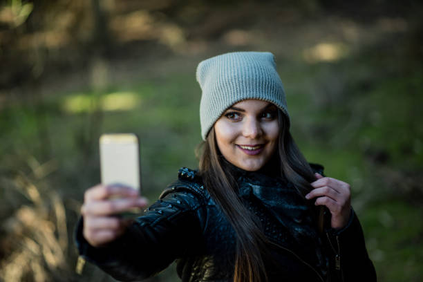 istock Woman taking selfie  in nature forest 1413845330
