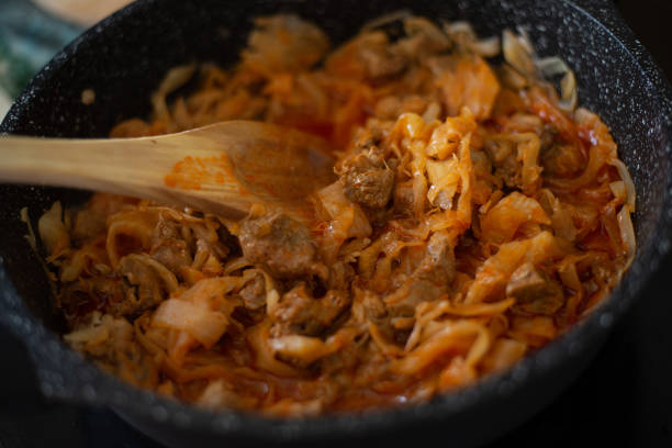 istock Stewed cabbage in a frying pan. Cooking recipe. 1413845509