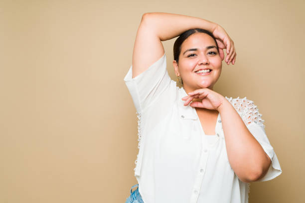 istock Beautiful plus size woman posing in front of a studio background 1413845674