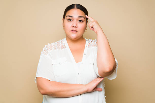 istock Thoughtful smart plus size woman making a thinking gesture 1413845707