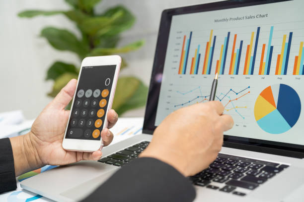 istock Asian accountant working and analyzing financial reports project accounting with chart graph in modern office, finance and business concept. 1413847145