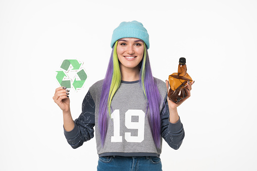 Happy caucasian eco-activist volunteer eco-friendly woman holding recycling sign logo against plastic pollution and plastic bottle, zero waste concept isolated in white background