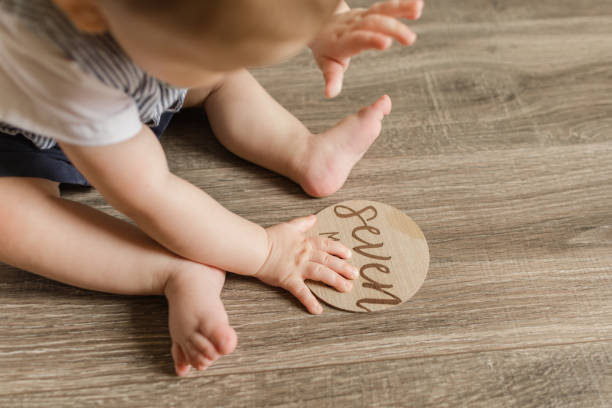 istock 7-Month-Old Baby Boy With Polydactylism Learning a New Developmental Skill of Sitting Up on His Own on a Wooden Floor at Home 1413848567