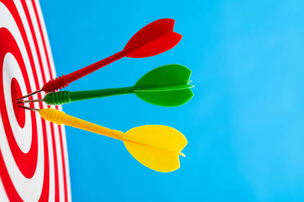 istock Dart arrows on center of dartboard 1413848593