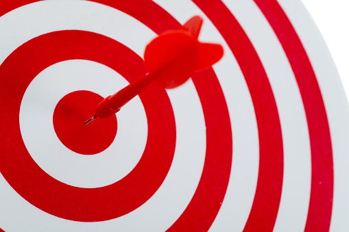 Dart arrow on center of dartboard.