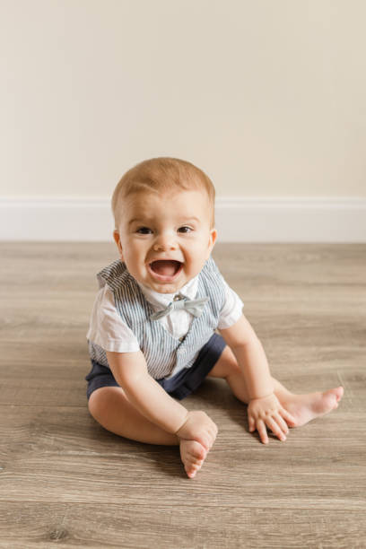 istock 7-Month-Old Baby Boy With Polydactylism Learning a New Developmental Skill of Sitting Up on His Own on a Wooden Floor at Home 1413848627