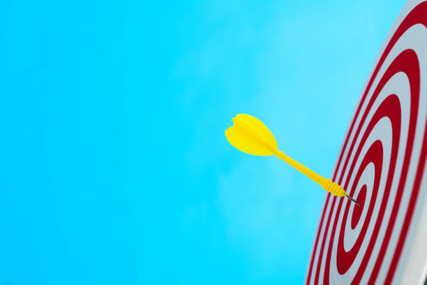 istock Dart arrow on center of dartboard 1413848644