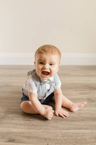 istock 7-Month-Old Baby Boy With Polydactylism Learning a New Developmental Skill of Sitting Up on His Own on a Wooden Floor at Home 1413848712