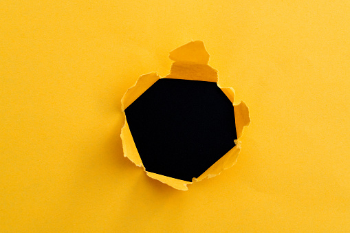 Yellow paper with a round hole.