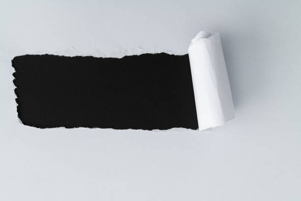 istock White paper tearing a hole 1413848825