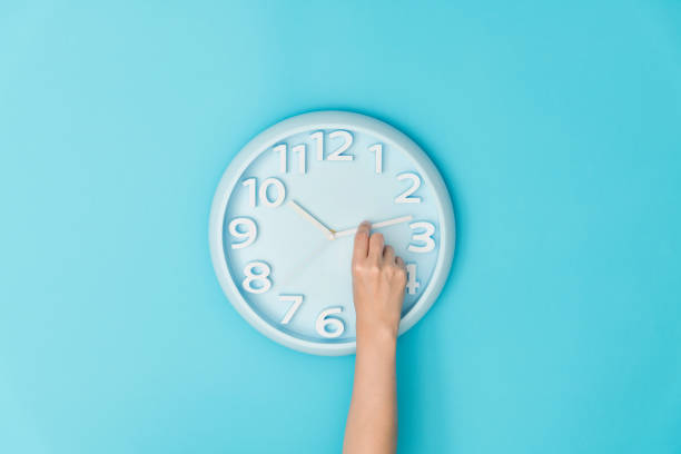 Human hand adjusting the hour clock Human hand adjusting the hour clock. hour hand stock pictures, royalty-free photos & images