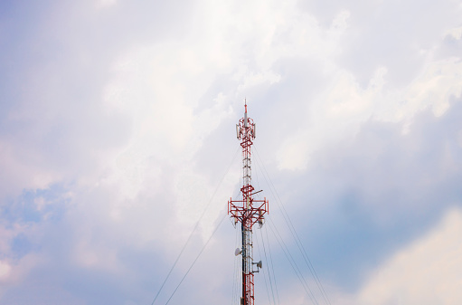 Telecommunication towers with colorful sky background.