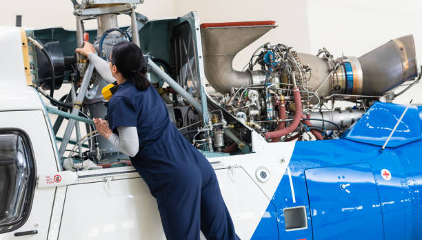 istock Female Aero Engineer Working On Helicopter In Hangar 1413851196