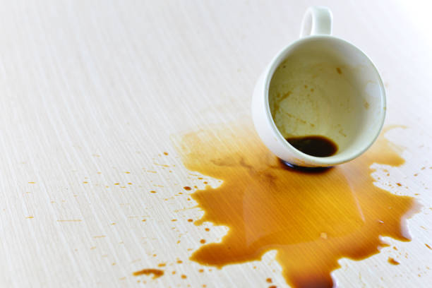 istock Spilled coffee cup stain on wooden floor 1413854378