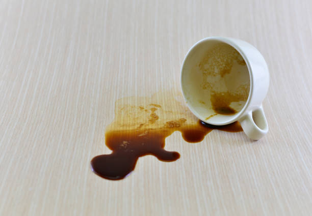 istock Spilled coffee cup stain on wooden floor 1413854379