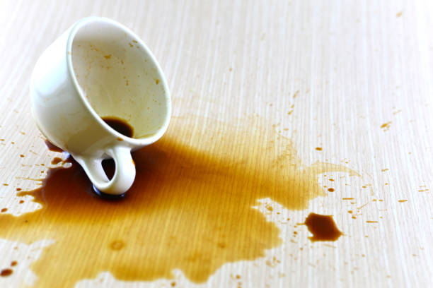 istock Spilled coffee cup stain on wooden floor 1413854383