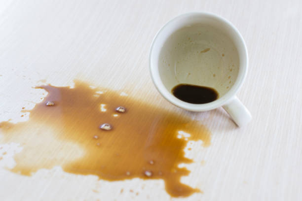 istock Spilled coffee cup stain on wooden floor 1413854429