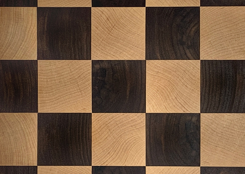 Closeup of a wood checkerboard.